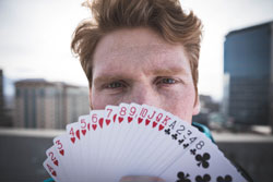 Magician holding a fan of playing cards
