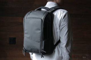 Man wearing a black NOMATIC backpack