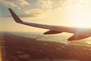 View from an airplane window over a coastline