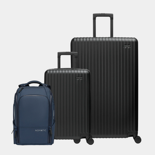 Set of black suitcases and a blue backpack on a light gray background#color_black