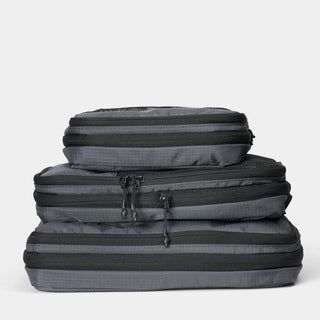 NOMATIC Compression Packing Cubes in gray, compressed and stacked, top view