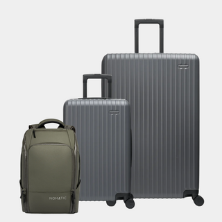 Set of gray suitcases and a green backpack on a light gray background#color_gray