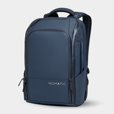 Navy NOMATIC Travel Pack 20L backpack with front organization, side pockets, padded shoulder straps, and multiple zippered compartments.