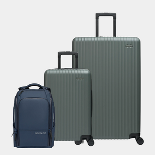 Three pieces of luggage including a navy backpack and two gray suitcases on a light gray background#color_moss