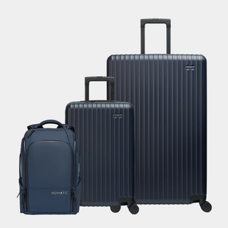 Set of three dark blue suitcases and a backpack on a light gray background#color_navy