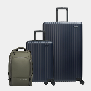 Two dark blue suitcases and a green backpack on a light gray background#color_navy