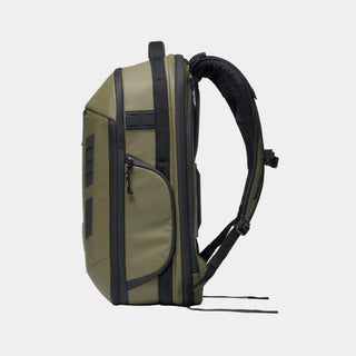 Side profile of an olive green and black technical backpack on a solid white background.