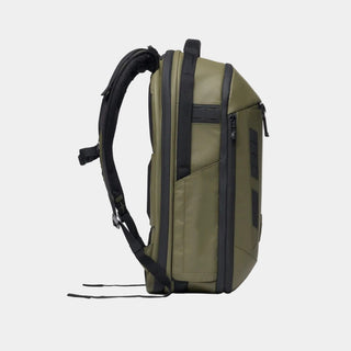 An olive green technical backpack shown from a side profile view against a clean white background.