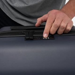 NOMATIC Carry-On Classic in navy, close-up detail of the integrated TSA lock and zipper pull